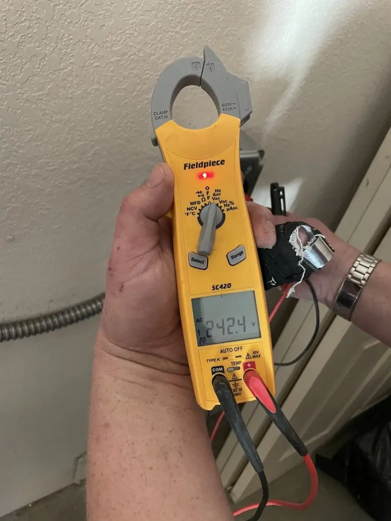 Voltage testing with clamp meter during Ceiling Fan Installation in Niles